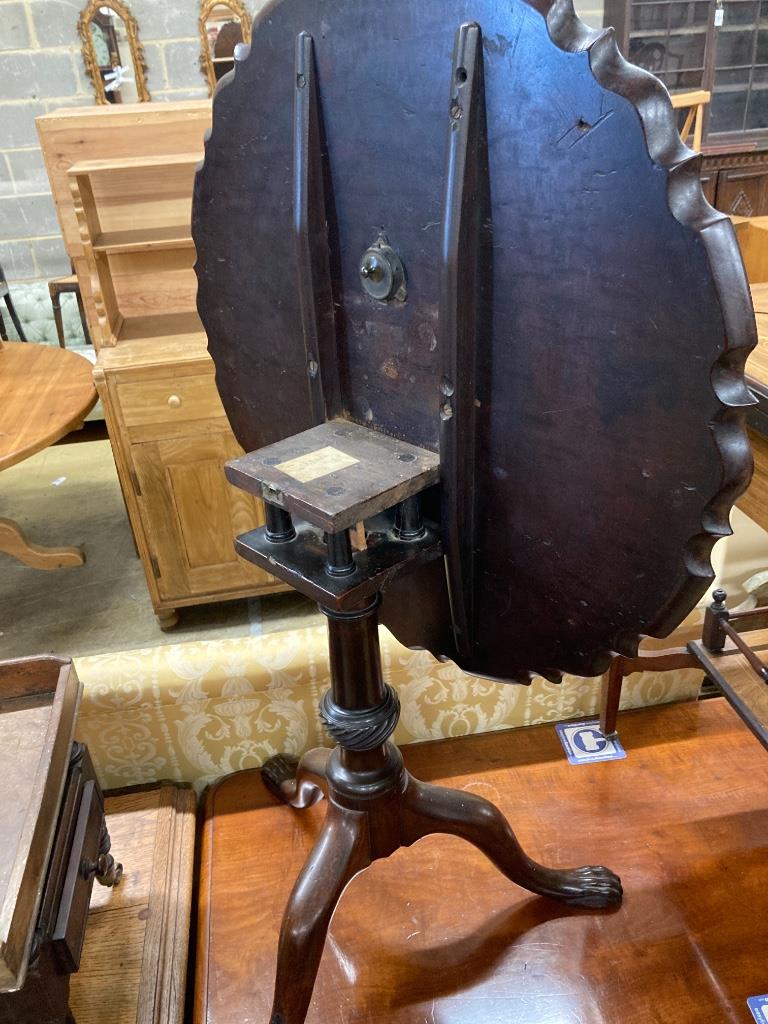 A George III style mahogany circular tripod table (later carved), 73cm diameter, height 70cm